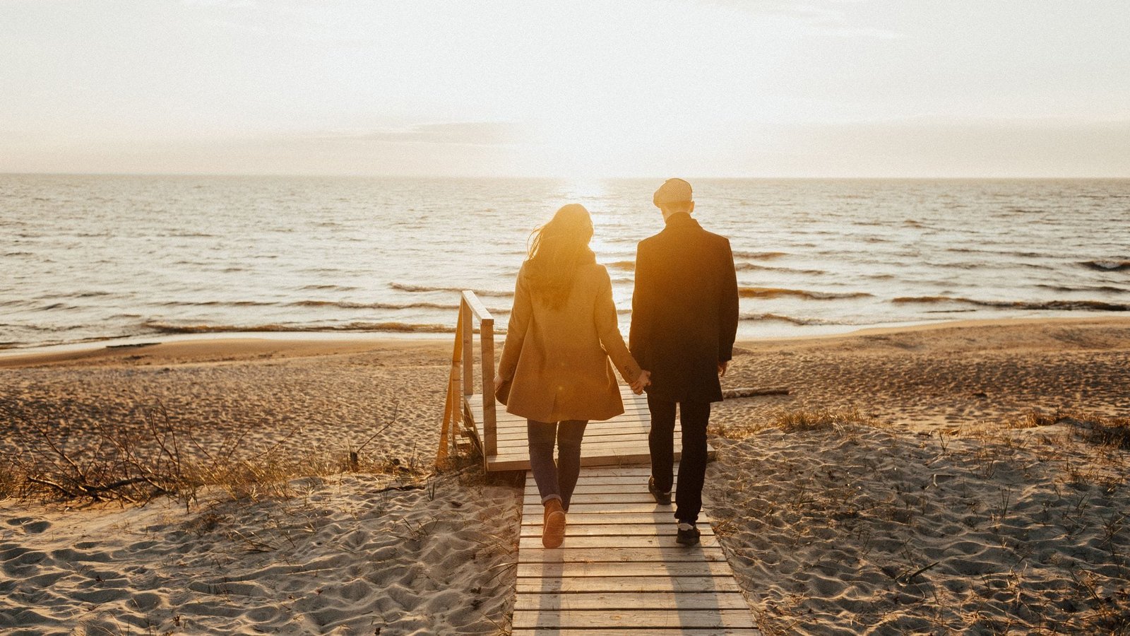 Husband and wife walking on beach